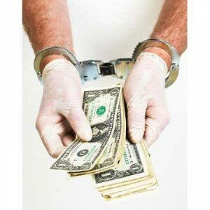 handcuffed-doctor-counting-out-money