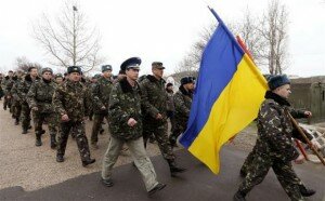 Ukrainian servicemen march away, after negotiations with Russian troops at the Belbek Sevastopol International Airport in the Crimea region